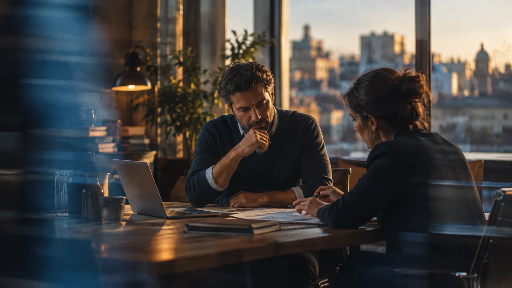 Illustrative executive team reviewing business reports in a warmly lit office